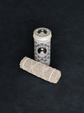 Blue Sage storage tin with black patterned design and a bundle of Blue Sage tied with white cotton string displayed in the foreground on a dark background