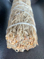 Blue Sage bundled with white cotton string on a dark background
