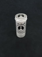 Silver metal storage tin with black patterned design for eucalyptus on a dark background