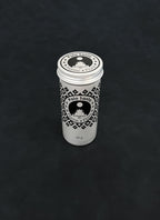 Silver metal storage tin with black patterned design for palo santo on a dark background