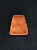 Bird’s-eye view of a rectangular acacia wood tray positioned vertically against a dark background