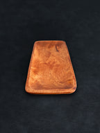 Bird’s-eye view of a rectangular acacia wood tray positioned vertically against a dark background