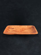Bird’s-eye view of a rectangular acacia wood tray positioned horizontally against a dark background